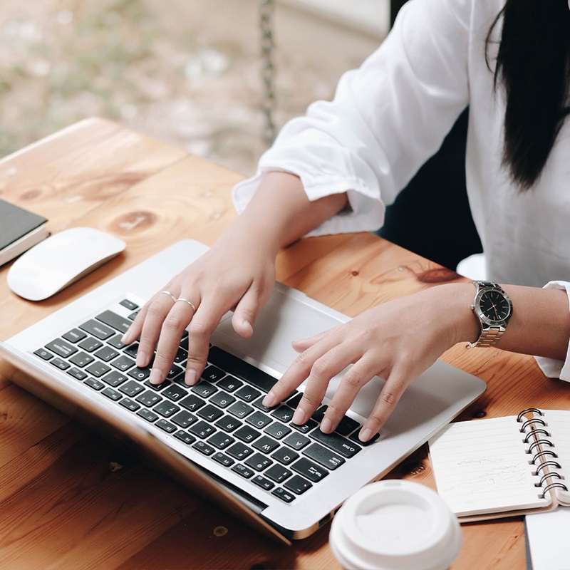 Close up of business professional typing at laptop