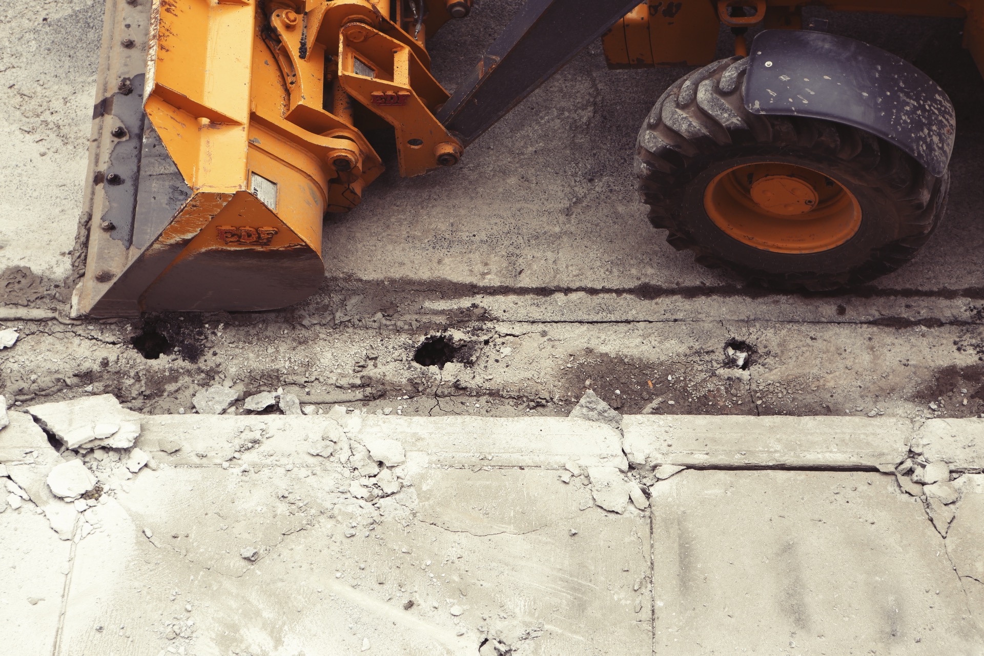 Construction vehicle reparing sidewalk